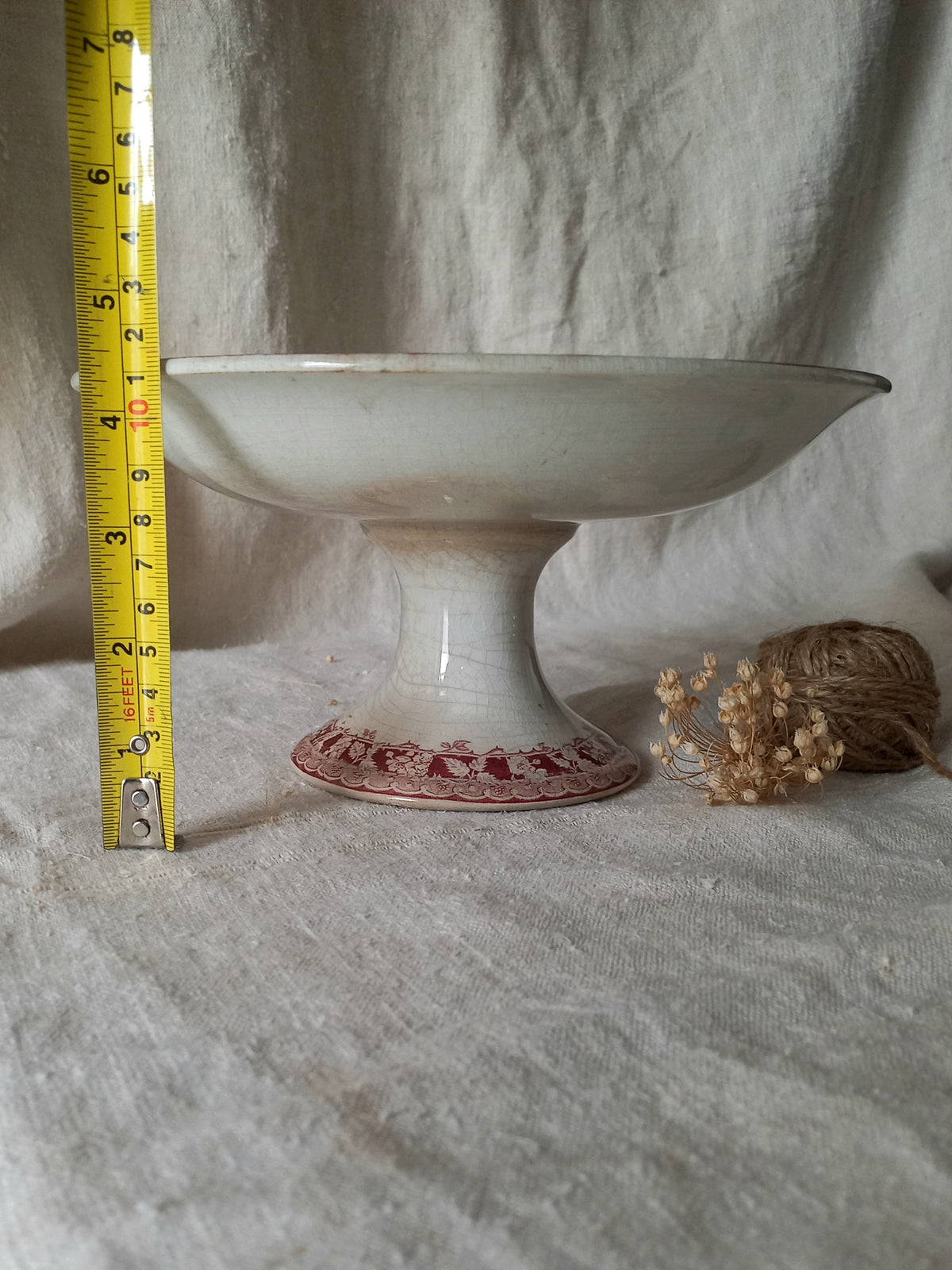 French antique ironstone/earthenware white patinated footed-dish with a pretty burgandy colour floral pattern with a tape measure for reference