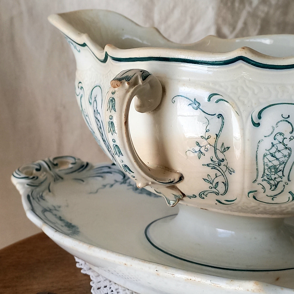 A large and elegant antique ironstone sauce boat with a green floral transferware pattern, a grand-looking, heavy piece. These days this piece will make an excellent piece of decor in any home, especially those of a country or farmhouse nature.