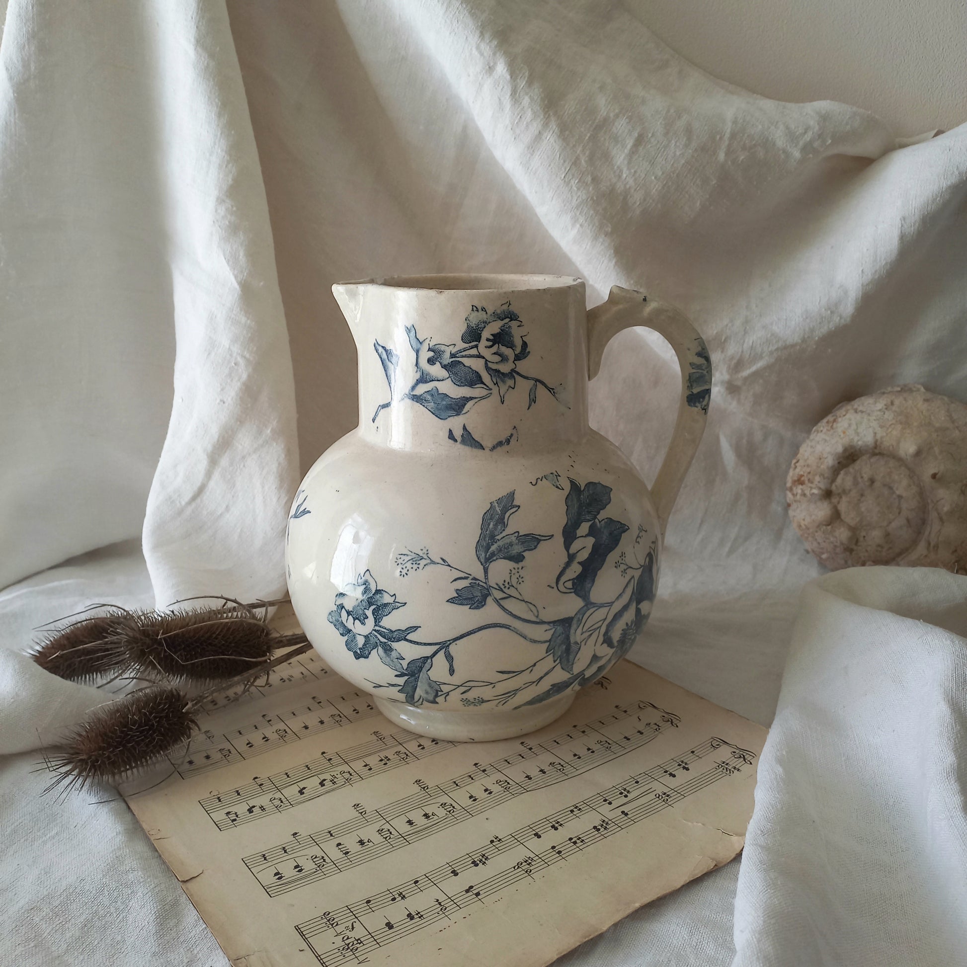 A large and beautiful French antique ironstone jug in a lovely aged white with blue floral transfer pattern. This wonderful piece of ironstone history has a super patina of age that gives it that look we all admire.