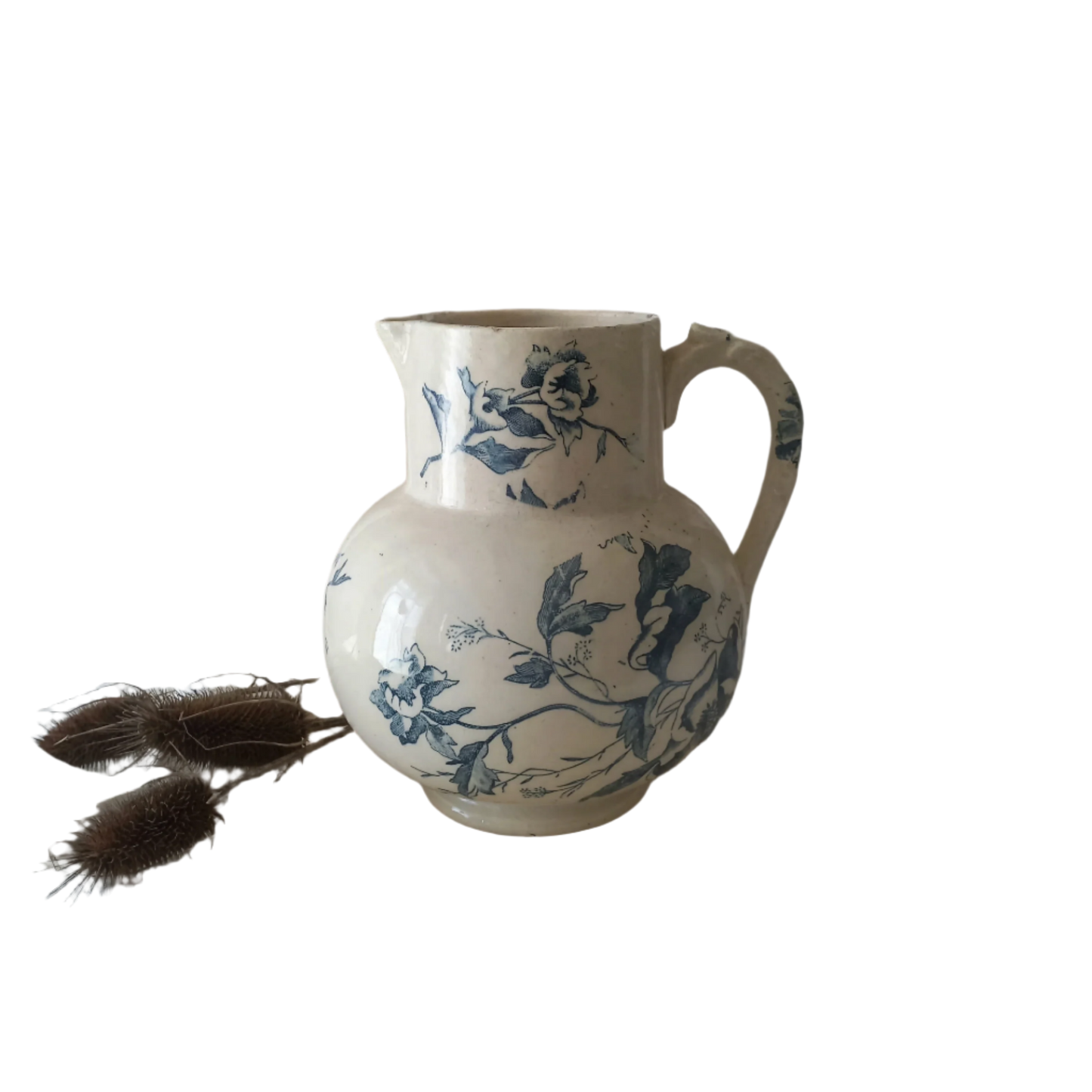 A large and beautiful French antique ironstone jug in a lovely aged white with blue floral transfer pattern. This wonderful piece of ironstone history has a super patina of age that gives it that look we all admire.