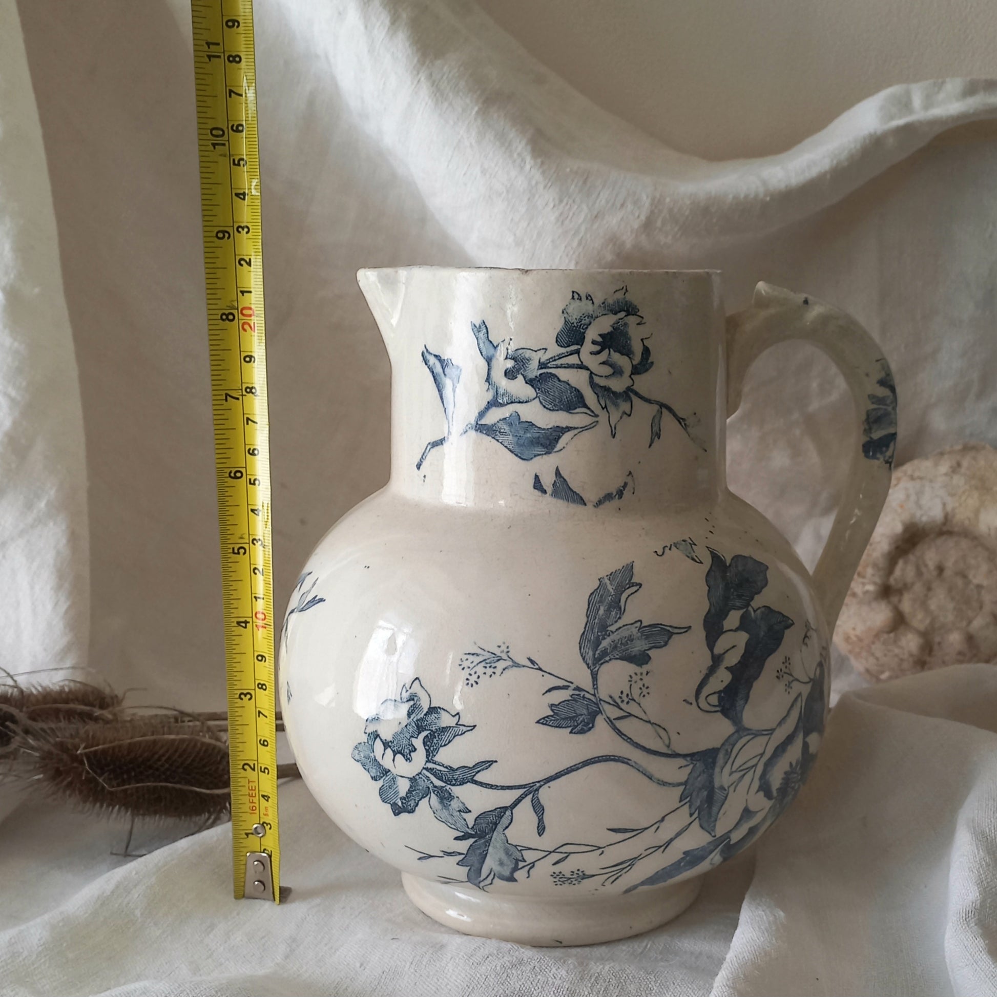 A large and beautiful French antique ironstone jug in a lovely aged white with blue floral transfer pattern. This wonderful piece of ironstone history has a super patina of age that gives it that look we all admire.