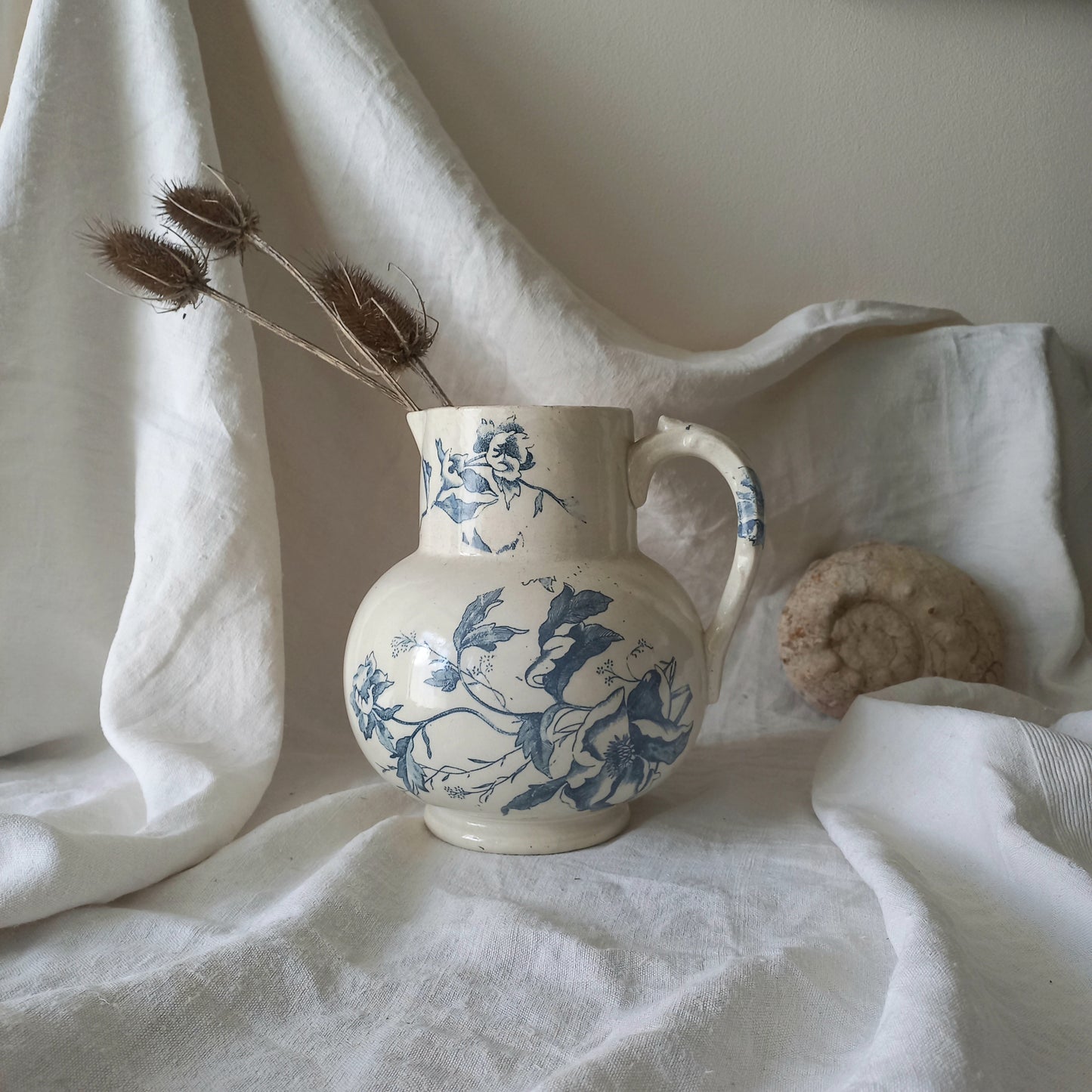 A large and beautiful French antique ironstone jug in a lovely aged white with blue floral transfer pattern. This wonderful piece of ironstone history has a super patina of age that gives it that look we all admire.