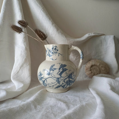 A large and beautiful French antique ironstone jug in a lovely aged white with blue floral transfer pattern. This wonderful piece of ironstone history has a super patina of age that gives it that look we all admire.