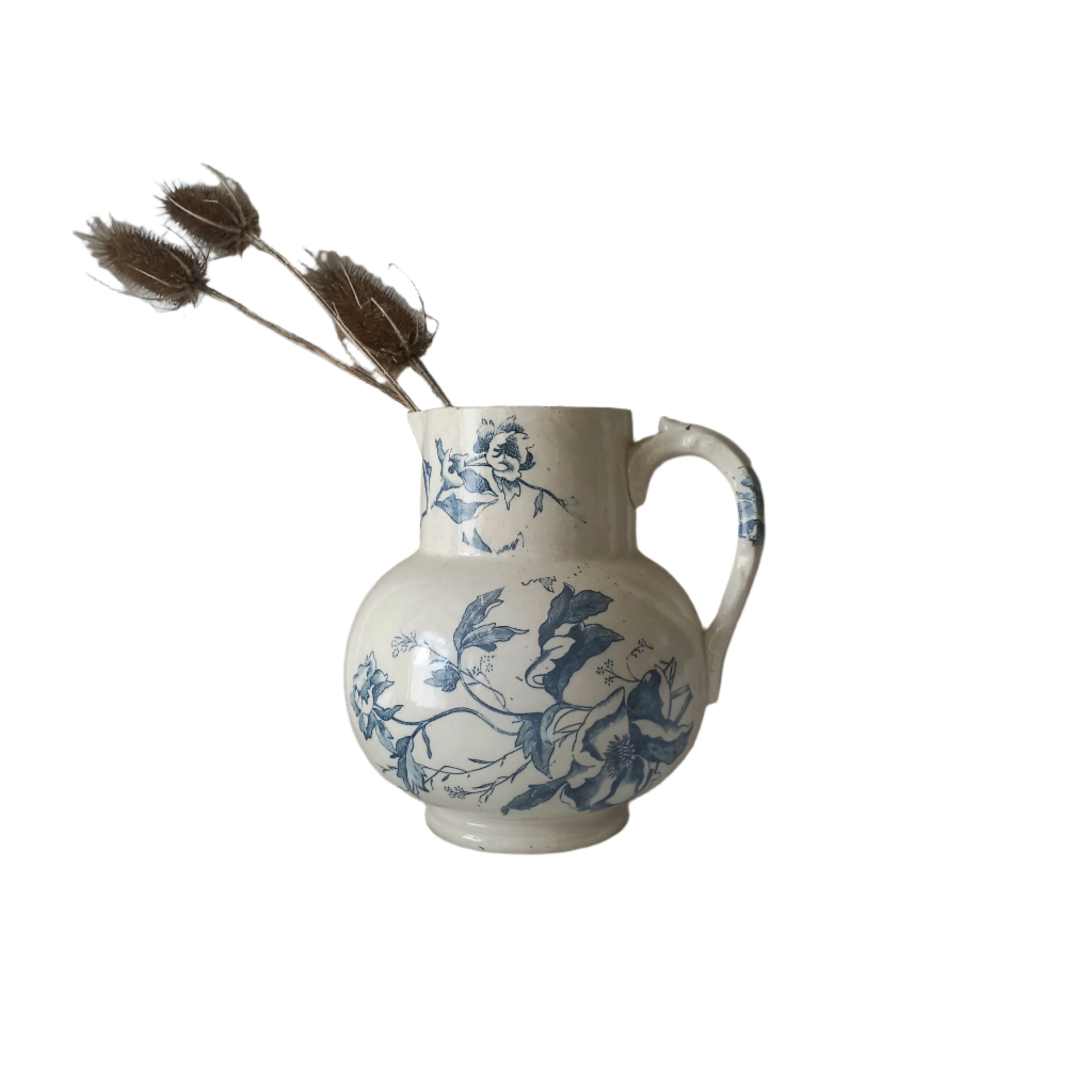 A large and beautiful French antique ironstone jug in a lovely aged white with blue floral transfer pattern. This wonderful piece of ironstone history has a super patina of age that gives it that look we all admire.