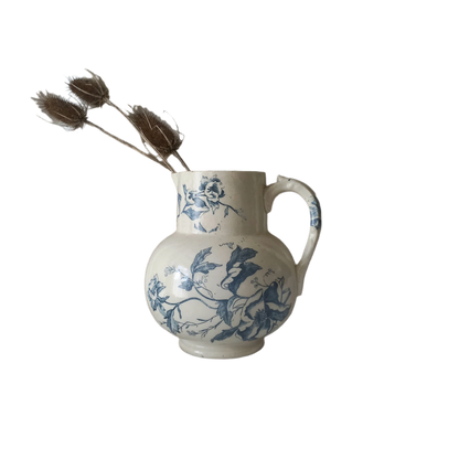 A large and beautiful French antique ironstone jug in a lovely aged white with blue floral transfer pattern. This wonderful piece of ironstone history has a super patina of age that gives it that look we all admire.