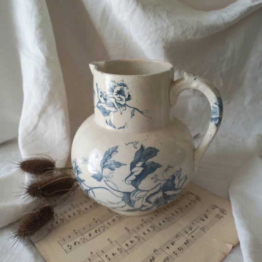 A large and beautiful French antique ironstone jug in a lovely aged white with blue floral transfer pattern. This wonderful piece of ironstone history has a super patina of age that gives it that look we all admire.