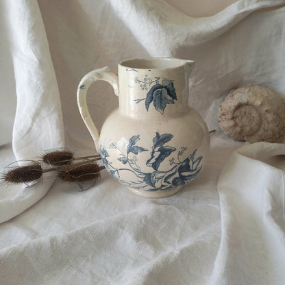 A large and beautiful French antique ironstone jug in a lovely aged white with blue floral transfer pattern. This wonderful piece of ironstone history has a super patina of age that gives it that look we all admire.