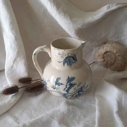 A large and beautiful French antique ironstone jug in a lovely aged white with blue floral transfer pattern. This wonderful piece of ironstone history has a super patina of age that gives it that look we all admire.