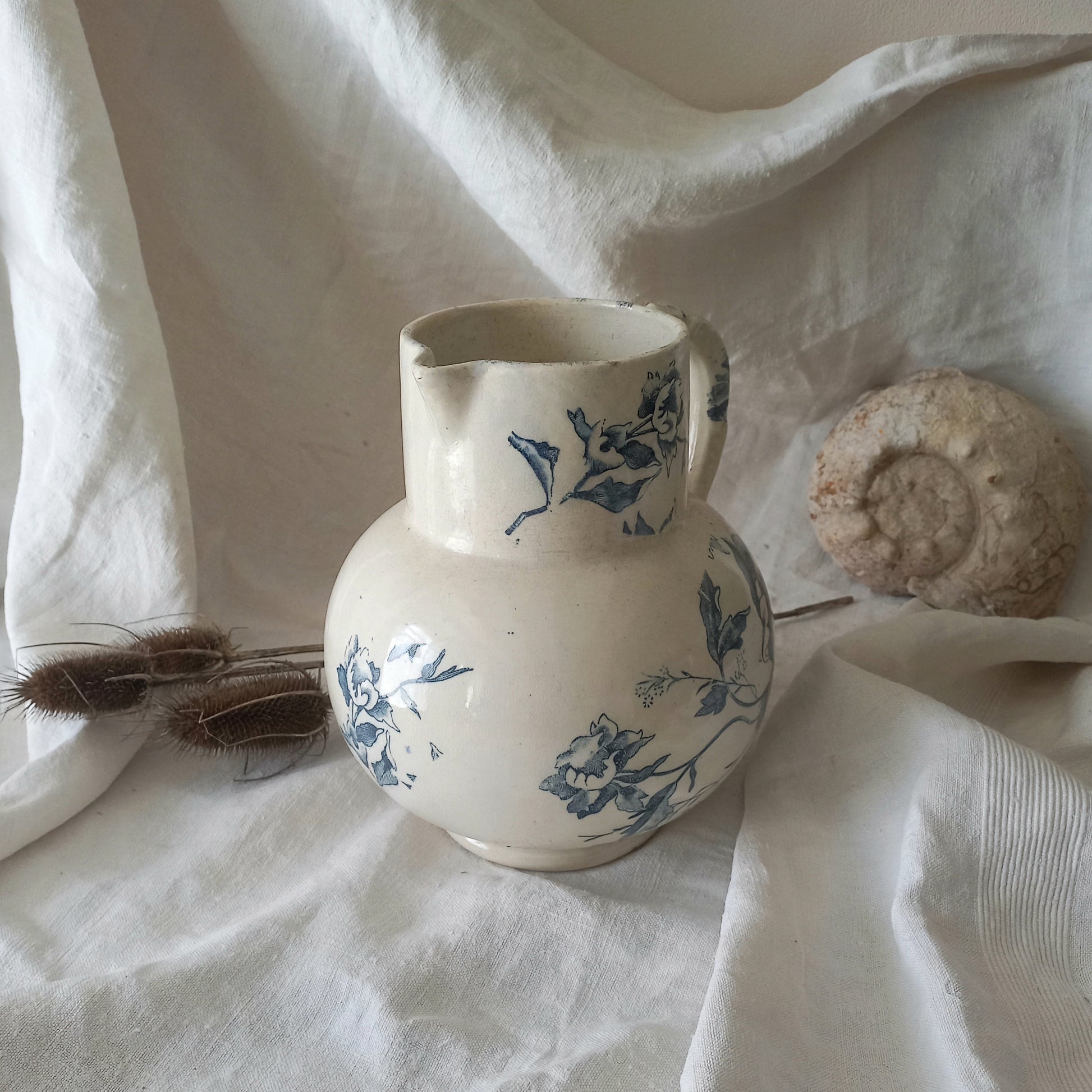 A large and beautiful French antique ironstone jug in a lovely aged white with blue floral transfer pattern. This wonderful piece of ironstone history has a super patina of age that gives it that look we all admire.