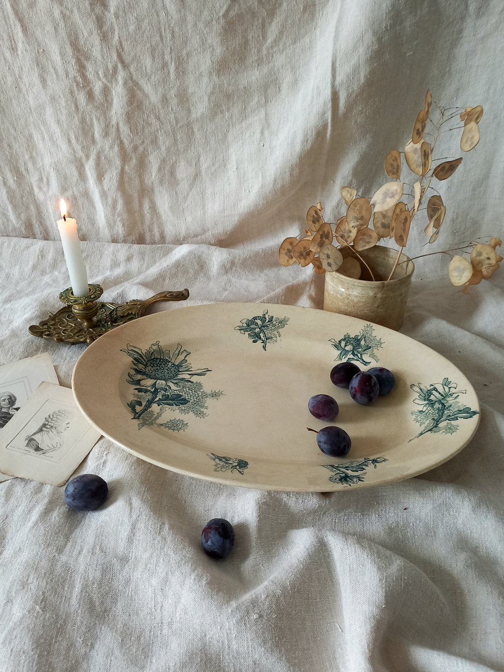 French antique oval ironstone serving plate with teal colour sunflower transferware pattern that over many decades has become a pleasing, warm shade of creamy white with crazing and tea-staining. 