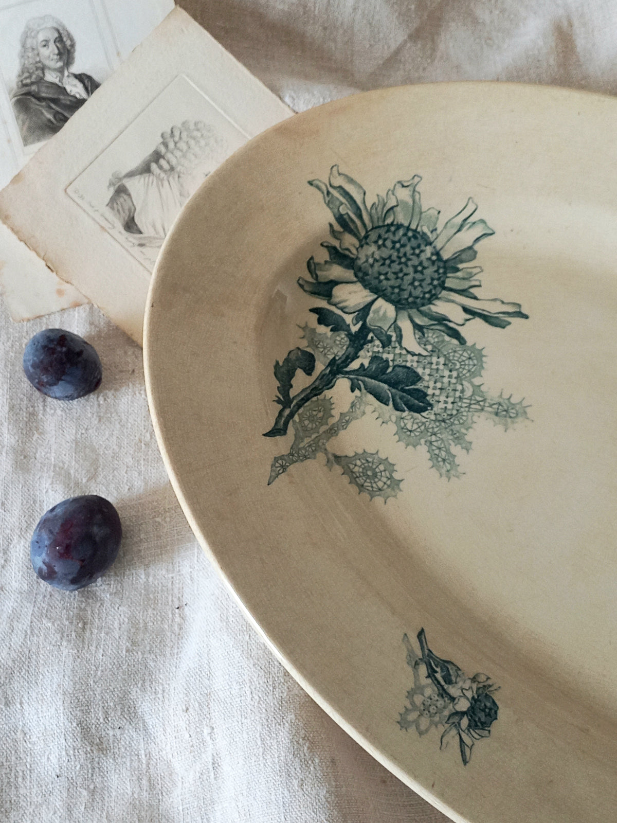 French antique oval ironstone serving plate with teal colour sunflower transferware pattern that over many decades has become a pleasing, warm shade of creamy white with crazing and tea-staining. 