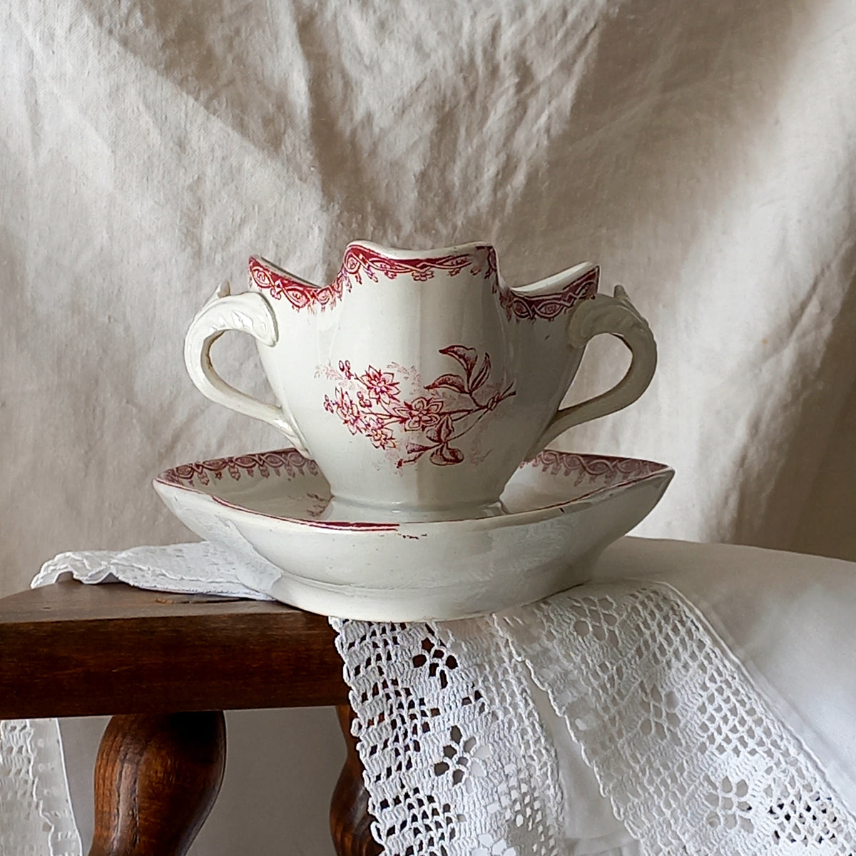 A beautiful French antique white ironstone gravy boat with a pretty pink floral transferware pattern, a heavy and quality piece manufactured by St. Amand. A great piece of decor in any home, and especially those of a rustic, country or farmhouse nature.