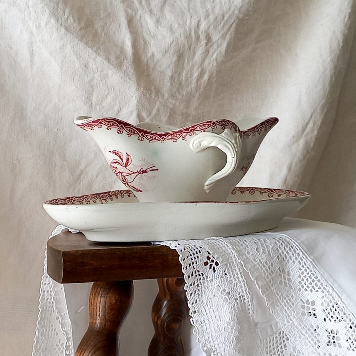 A beautiful French antique white ironstone gravy boat with a pretty pink floral transferware pattern, a heavy and quality piece manufactured by St. Amand. A great piece of decor in any home, and especially those of a rustic, country or farmhouse nature.