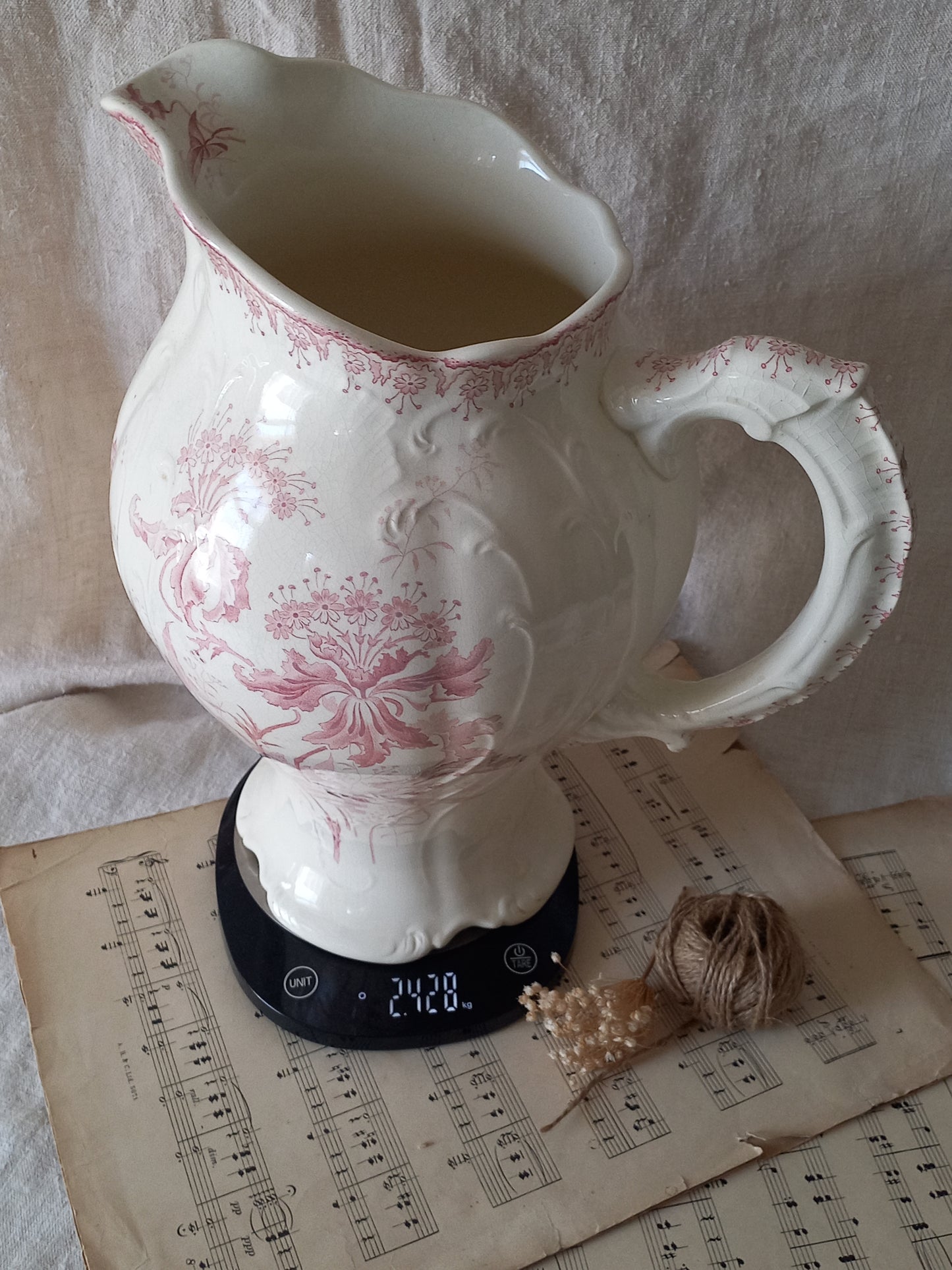 Close-up of Large French antique ironstone jug in a decorative setting.