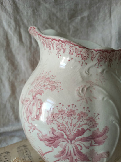 Close-up of Large French antique ironstone jug in a decorative setting.