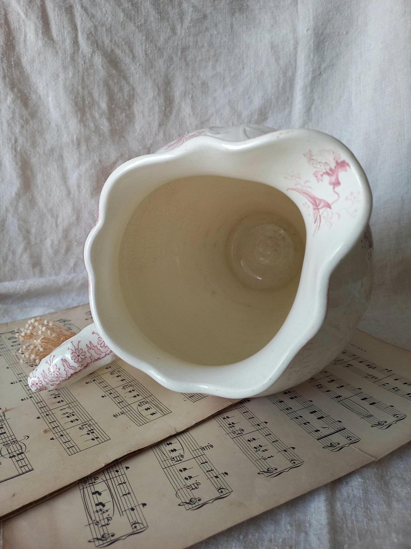 Close-up of Large French antique ironstone jug in a decorative setting.