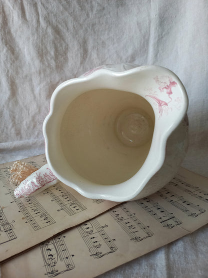Close-up of Large French antique ironstone jug in a decorative setting.