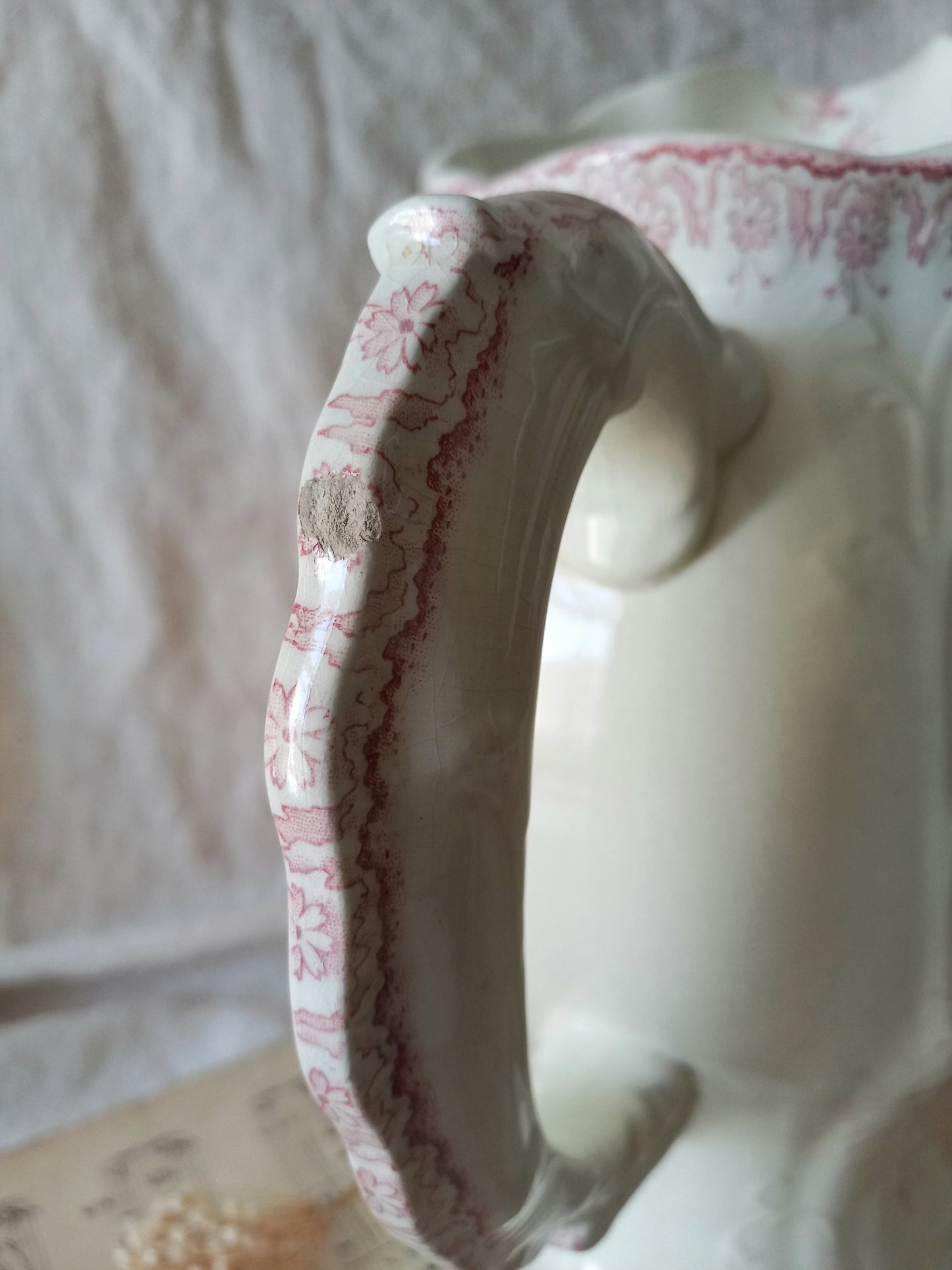 Close-up of Large French antique ironstone jug in a decorative setting.