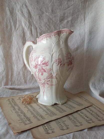 Large French antique ironstone jug in a decorative setting.