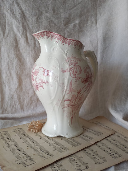 Large French antique ironstone jug in a decorative setting.