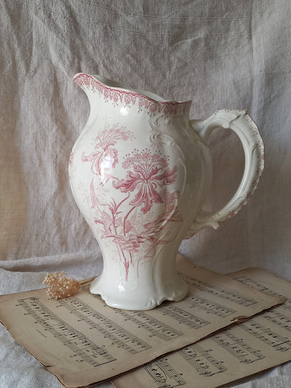 Large French antique ironstone jug in a decorative setting.