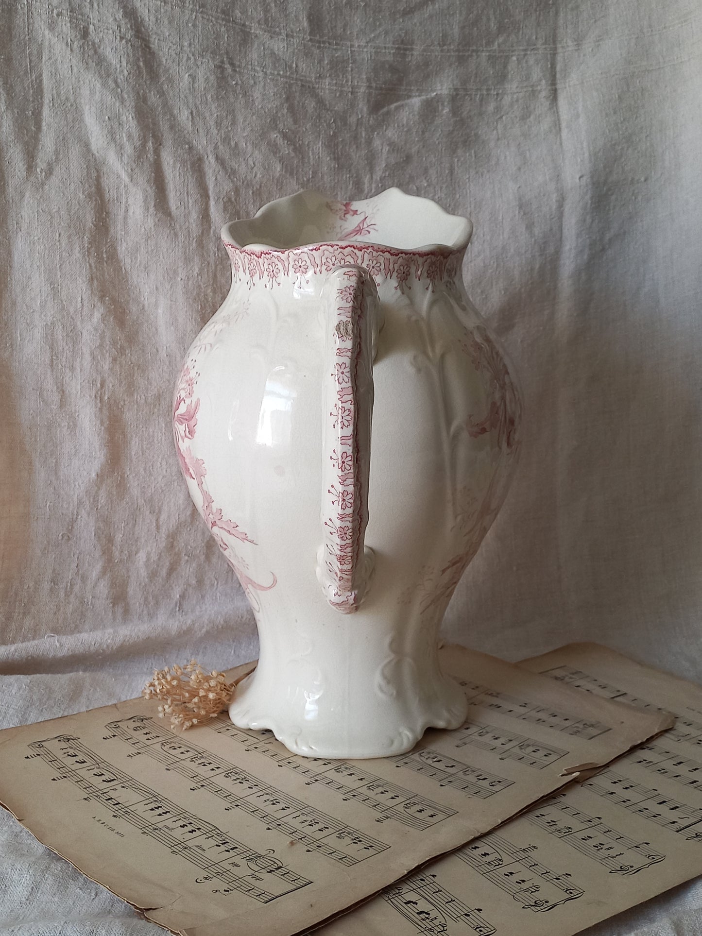 Large French antique ironstone jug in a decorative setting.