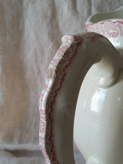 Close-up of Large French antique ironstone jug in a decorative setting.
