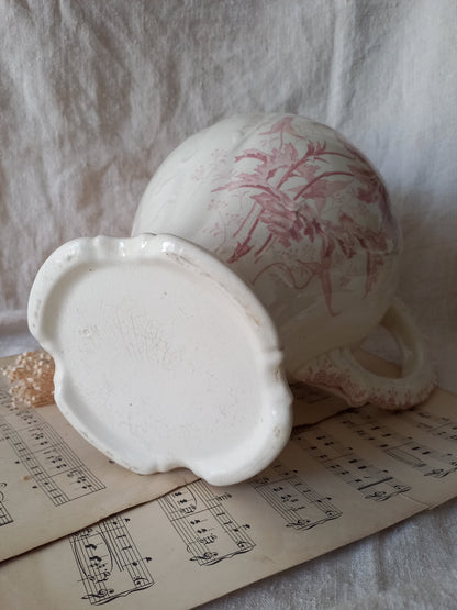 Close-up of Large French antique ironstone jug in a decorative setting.