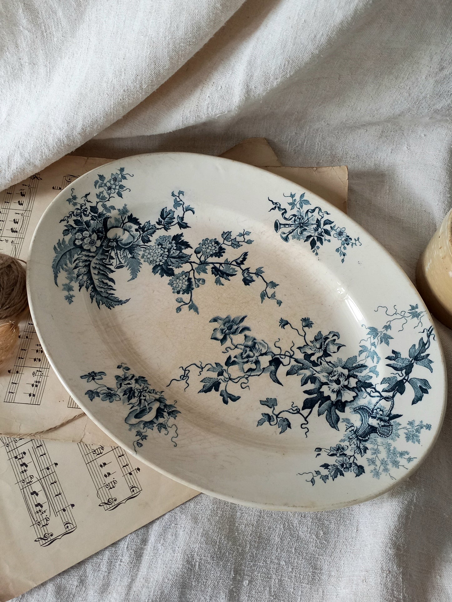 Ceramic plate with blue floral design on a textured surface