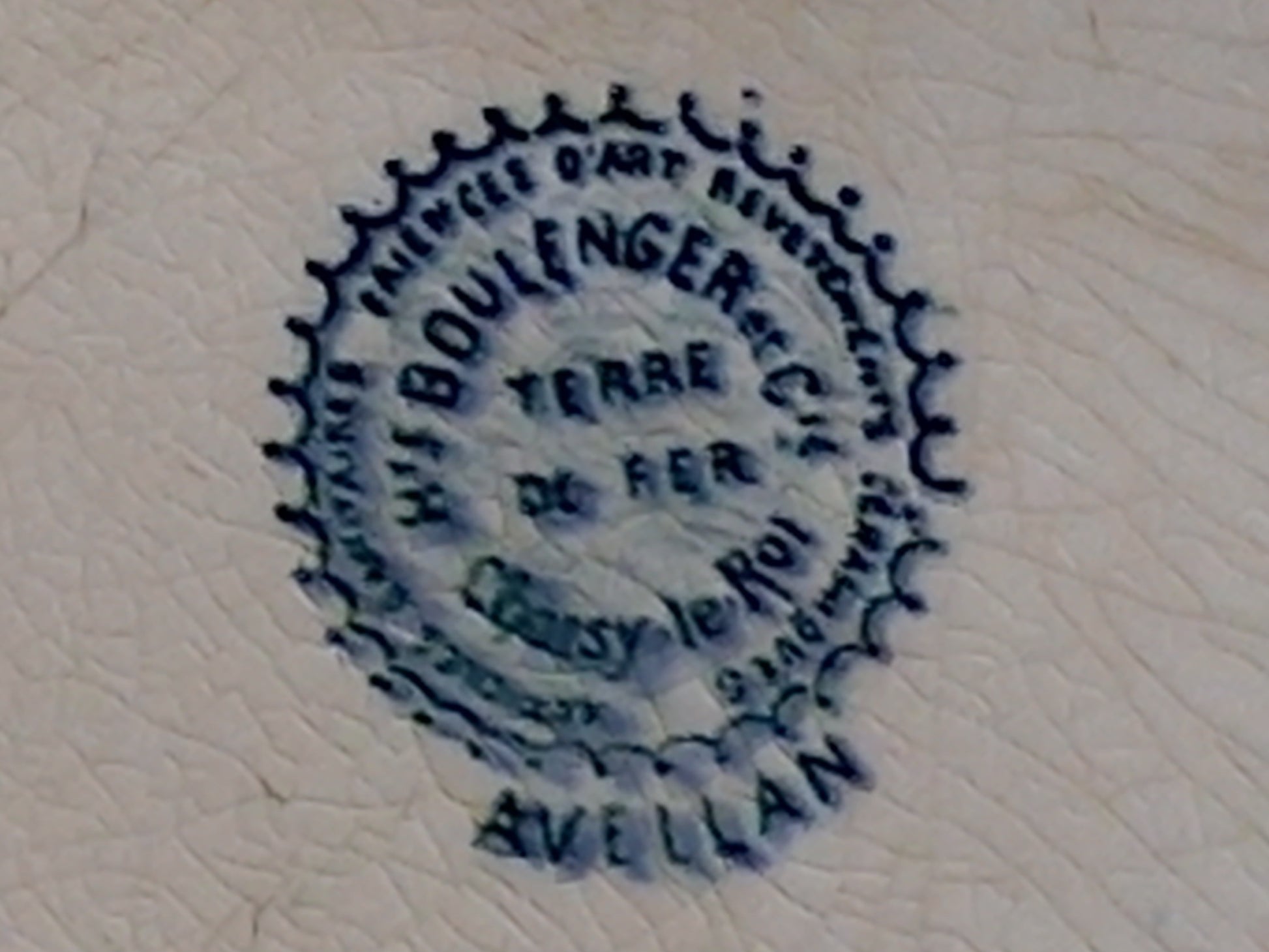 Circular blue stamp with text on a textured beige background