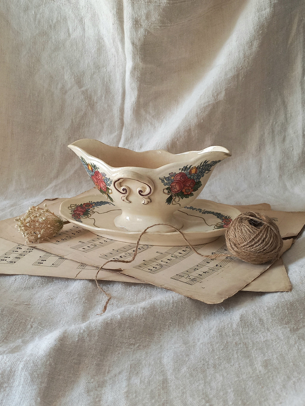 Stunning French vintage ironstone gravy boat with pretty floral patterns. This particular piece of ironstone was manufactured by premier French company, Sarreguemines. 