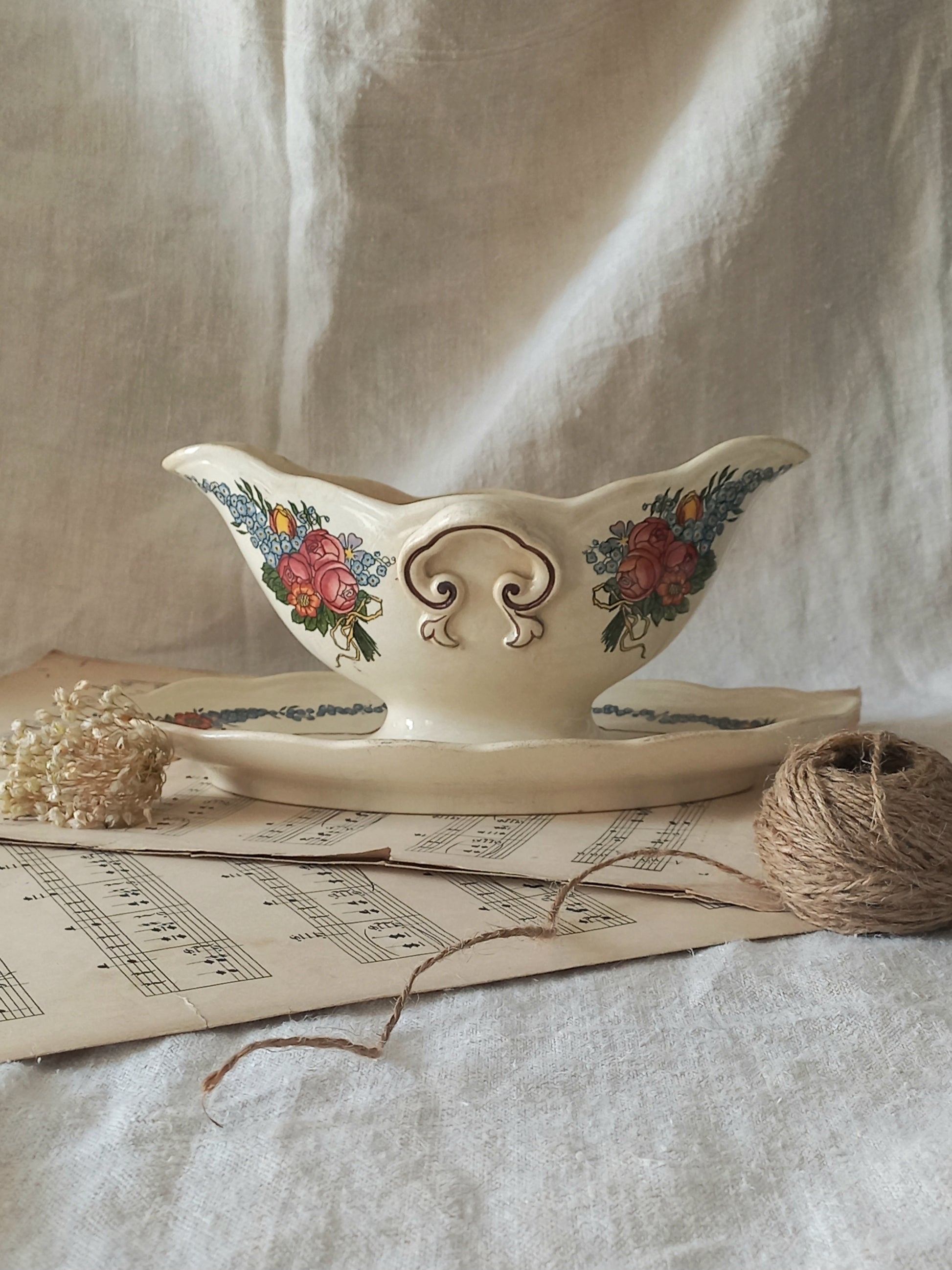 Stunning French vintage ironstone gravy boat with pretty floral patterns. This particular piece of ironstone was manufactured by premier French company, Sarreguemines. 