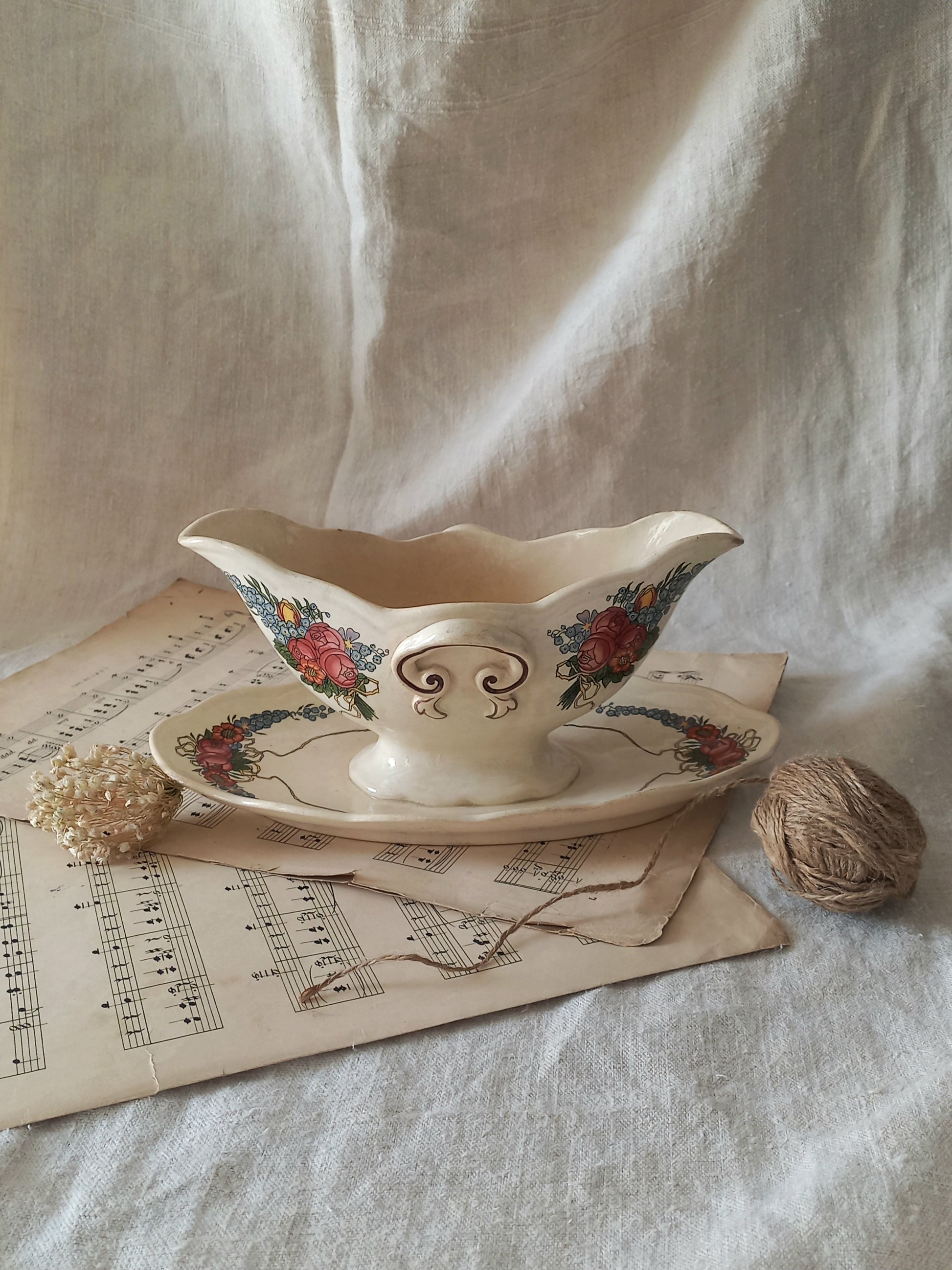 Stunning French vintage ironstone gravy boat with pretty floral patterns. This particular piece of ironstone was manufactured by premier French company, Sarreguemines. 