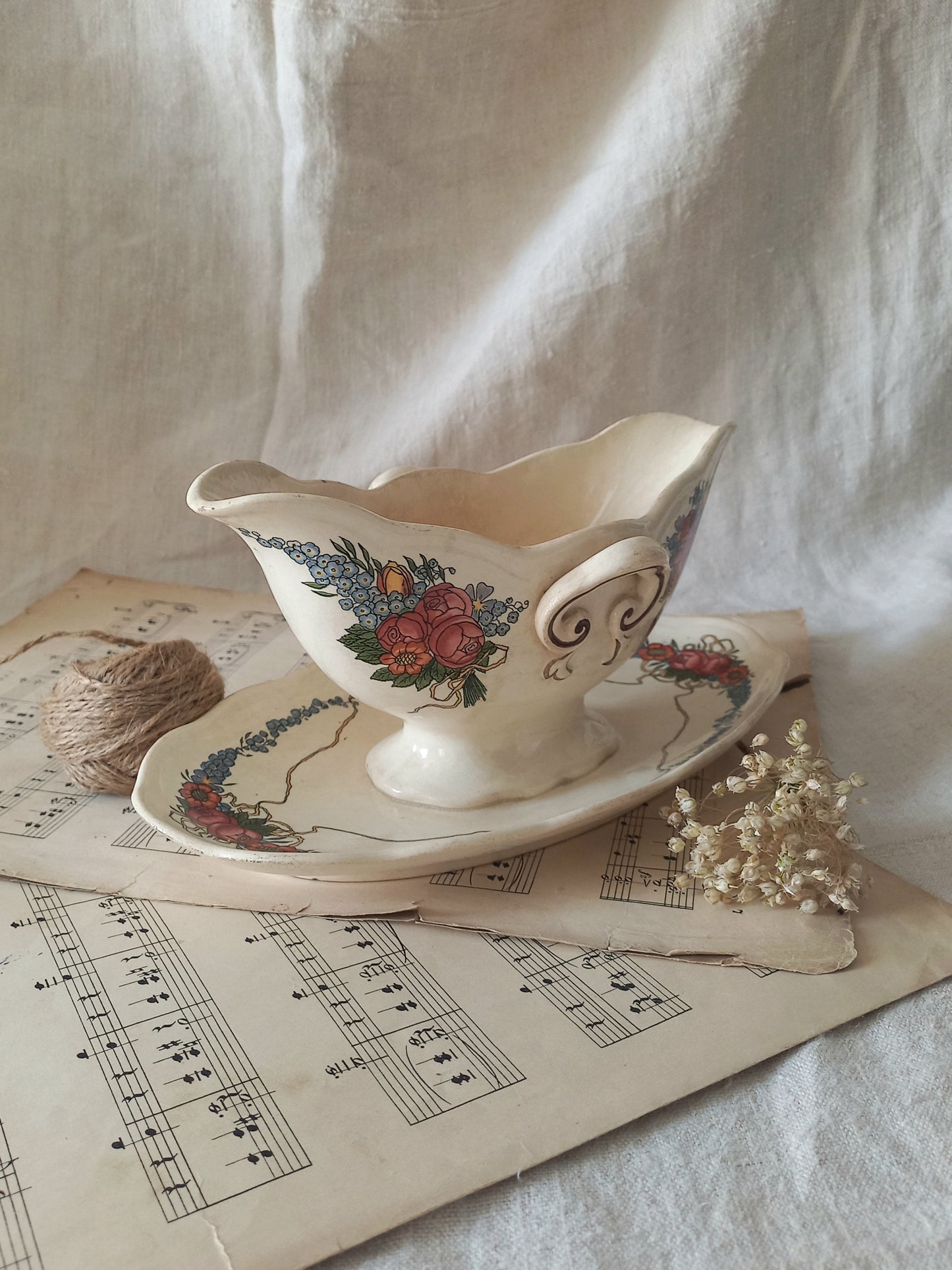 Stunning French vintage ironstone gravy boat with pretty floral patterns. This particular piece of ironstone was manufactured by premier French company, Sarreguemines. 