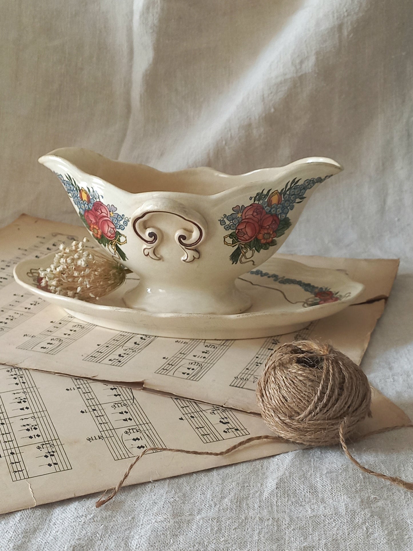 Stunning French vintage ironstone gravy boat with pretty floral patterns. This particular piece of ironstone was manufactured by premier French company, Sarreguemines. 