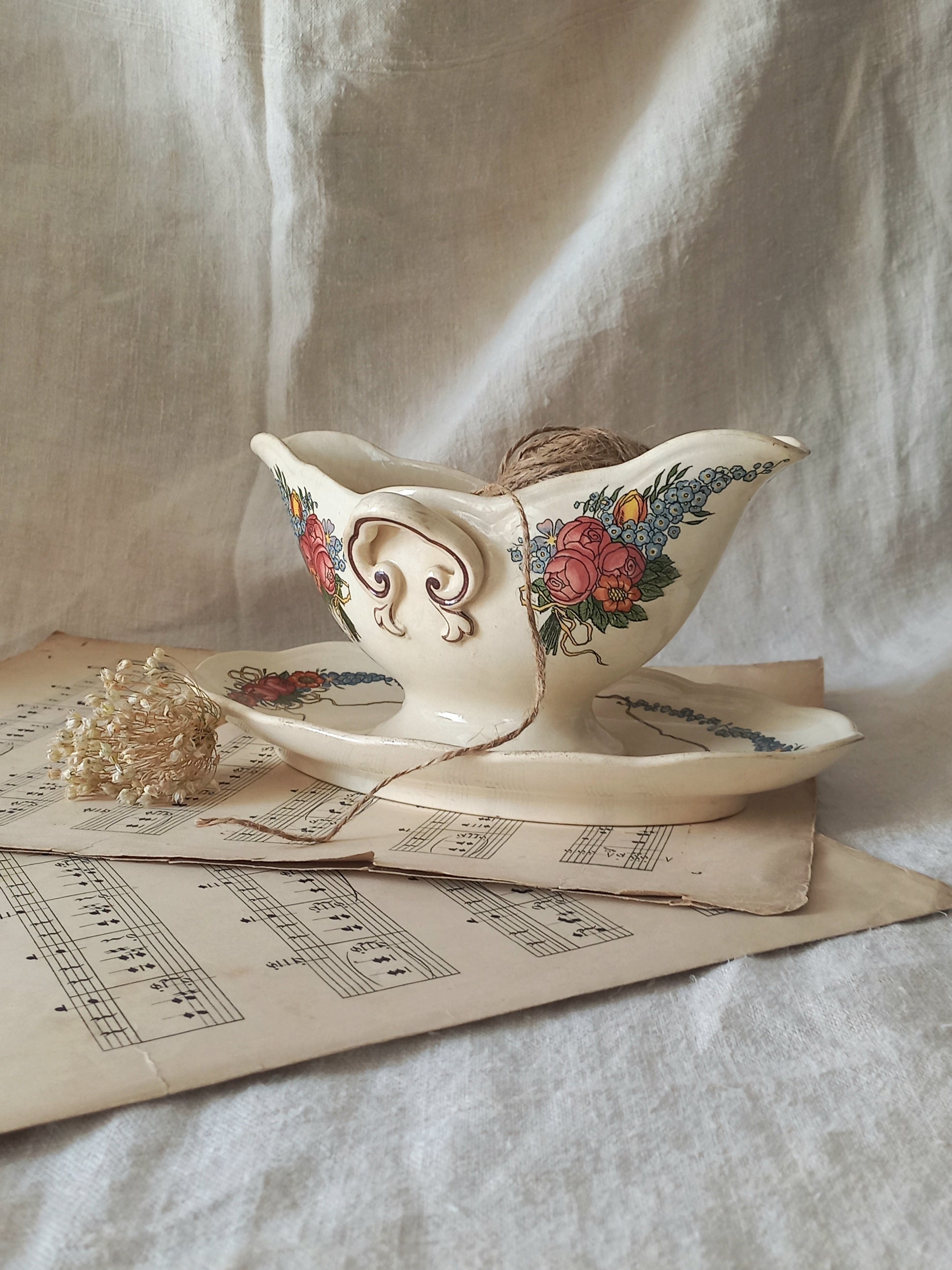 Stunning French vintage ironstone gravy boat with pretty floral patterns. This particular piece of ironstone was manufactured by premier French company, Sarreguemines. 