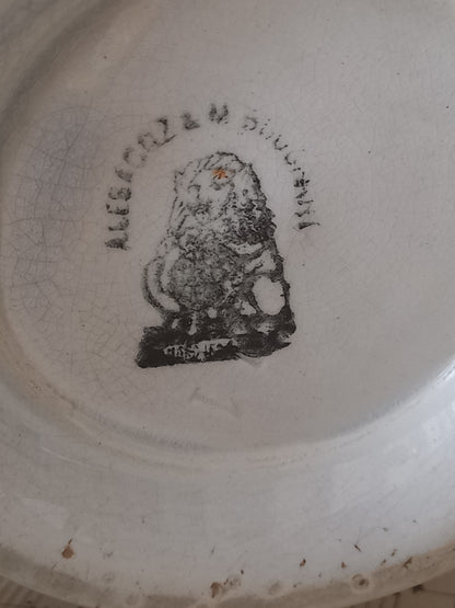 Close-up of a French antique white ironstone jug or pitcher with swan neck handle in a decorative setting.