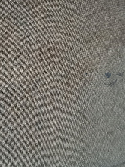 A close-up of a textured stretched canvas in a muted taupe-gray color, showing the detailed knit pattern and subtle tonal variations.