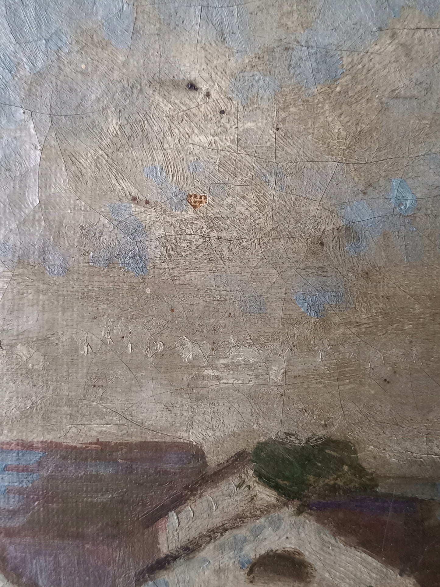 A close-up of a textured painting showing a rustic sky with blue patches and a small section of a house with a green tree above it.