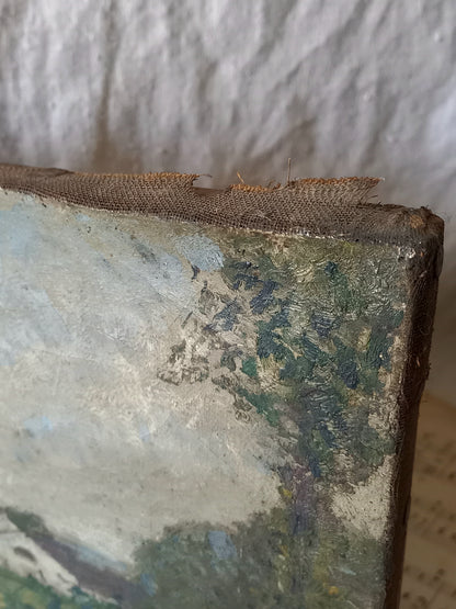 Close-up of a distressed canvas painting showing the rough, textured edge with peeling paint and a frayed fabric strip along the top, set against a neutral background.