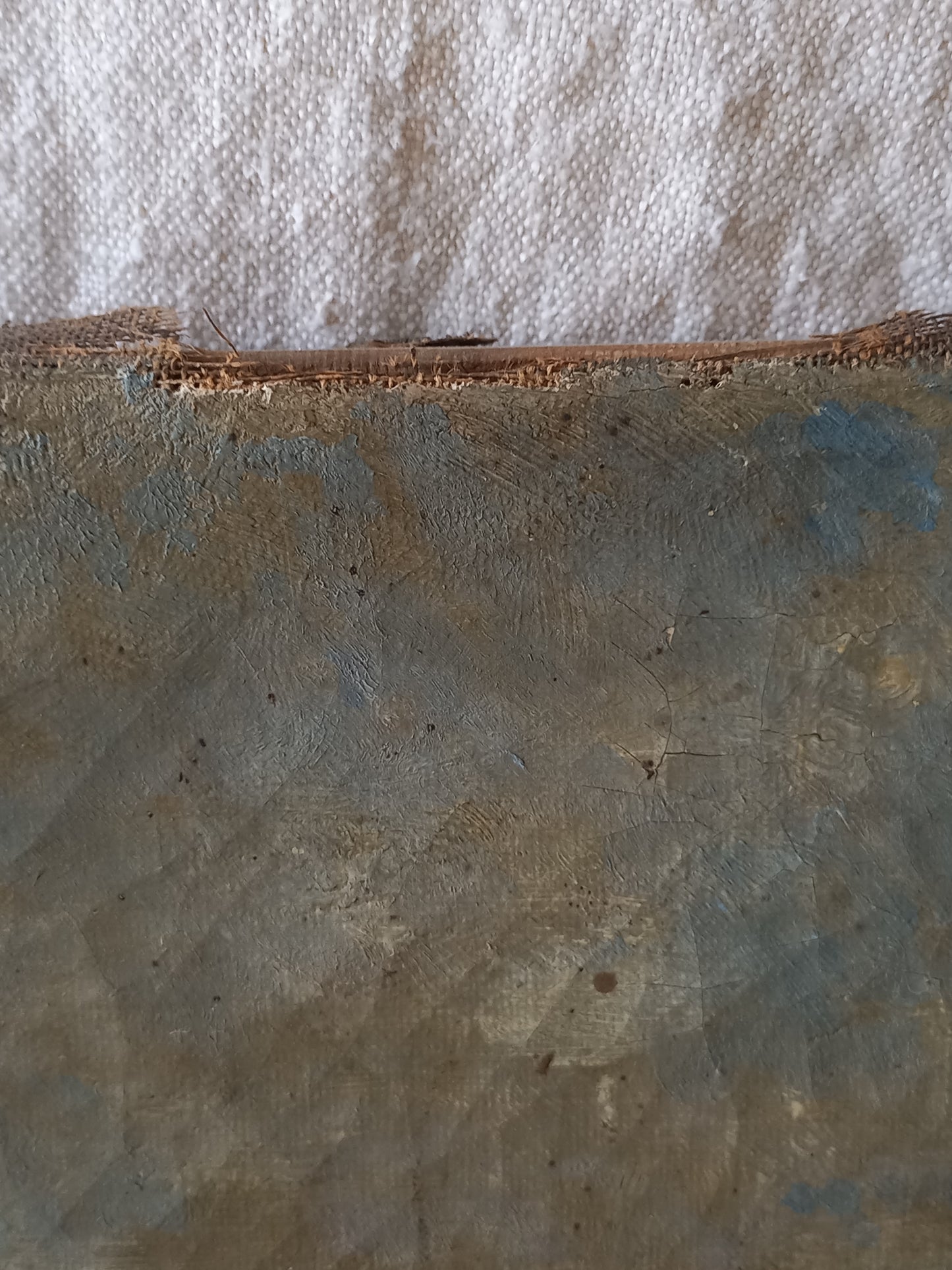 A close-up of a distressed, weathered antique canvas
