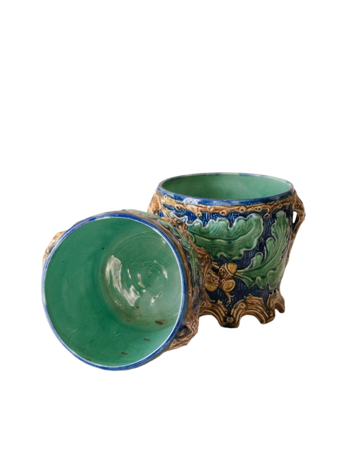 A stunning pair of French antique majolica planters, absolutely glorious fresh blue and green colours with oak leafs and acorns in relief making these stunning pieces of interior home decor wherever you decide to display them.

One of the planters has an antique repair in the form of metal staples that have been expertly done from the inside - in the 1800s and early 1900s this was quite a common repair to have made on items of high value and we feel it only adds to the authenticity/story of these pieces.