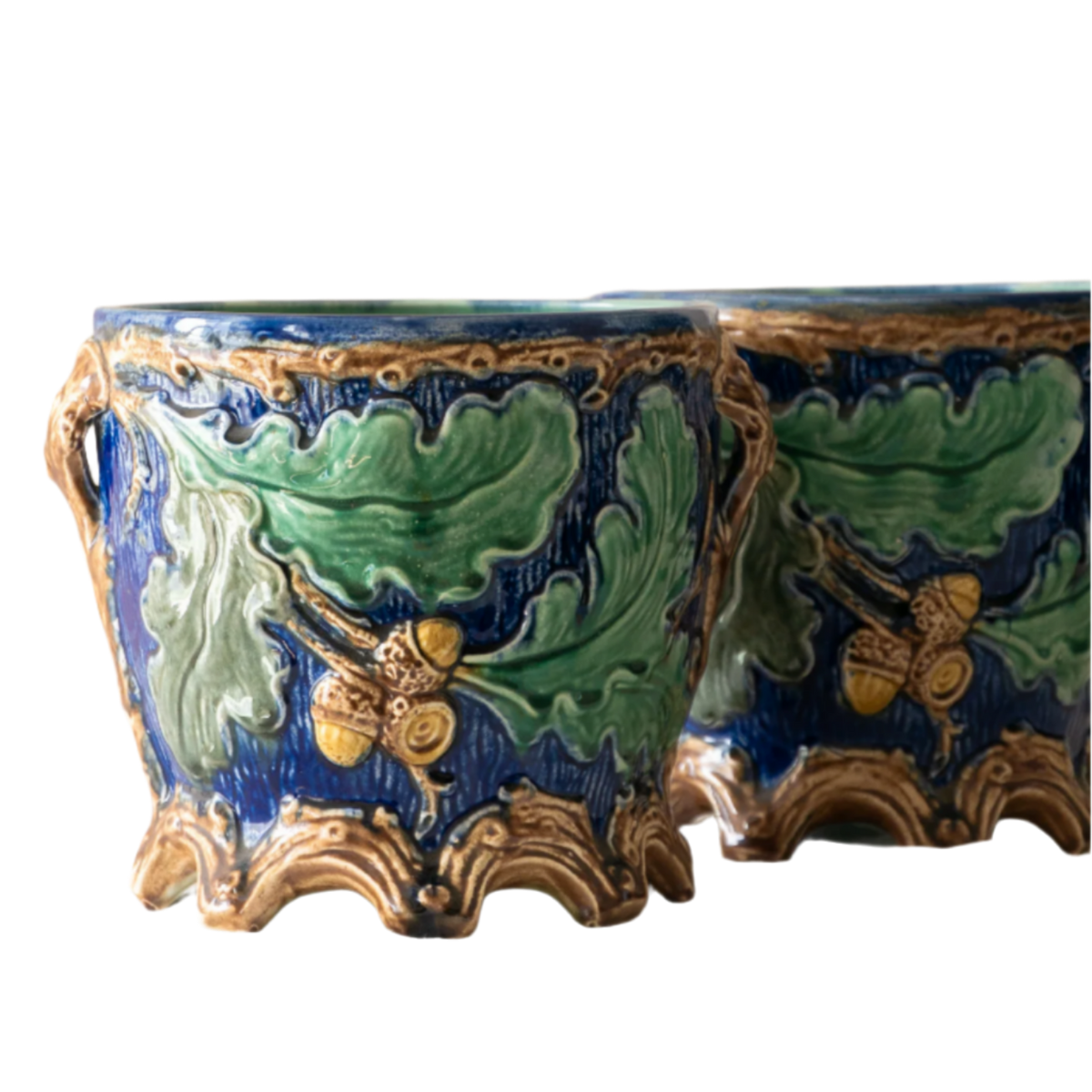 A stunning pair of French antique majolica planters, absolutely glorious fresh blue and green colours with oak leafs and acorns in relief making these stunning pieces of interior home decor wherever you decide to display them.

One of the planters has an antique repair in the form of metal staples that have been expertly done from the inside - in the 1800s and early 1900s this was quite a common repair to have made on items of high value and we feel it only adds to the authenticity/story of these pieces.