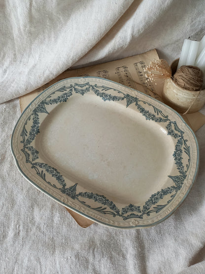 Oval ceramic platter with decorative blue patterns on a textured surface