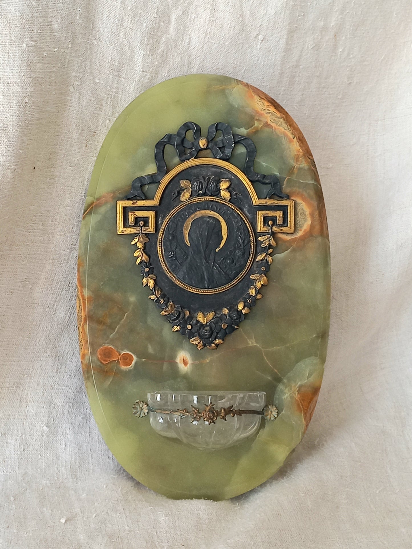 French antique Holy Water font made from onyx with intricate decorative detailing made from metal, a glass water font , and a brass back-plate with a hanging hook.