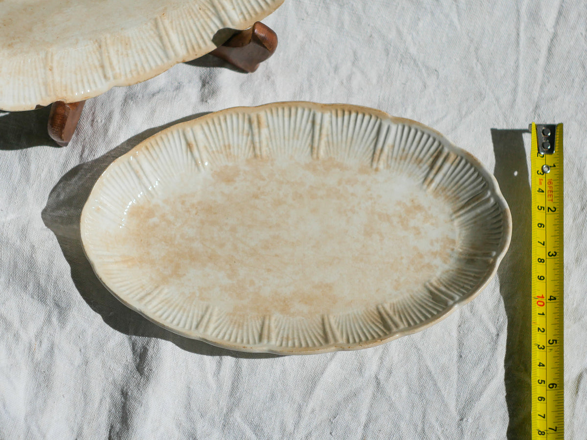 A beautiful pair of French antique ironstone raviers or side plates which over the last century or more have developed a wonderful time-worn and tea-stained finish which make them perfect for shabby chic interior decor. We very rarely come across these little plates lately they're a rare find.