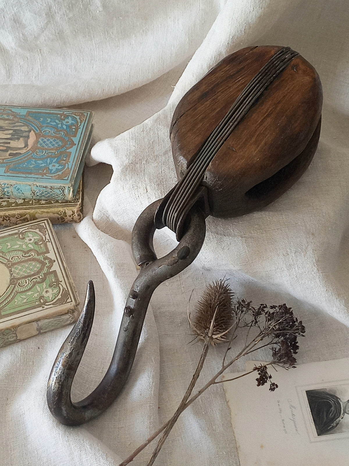 A beautiful aged antique wooden pulley block with a heavy metal hanging hook - a really fantastic piece with many decorative possibilities such a plant hanger or nautical/coastal decor.