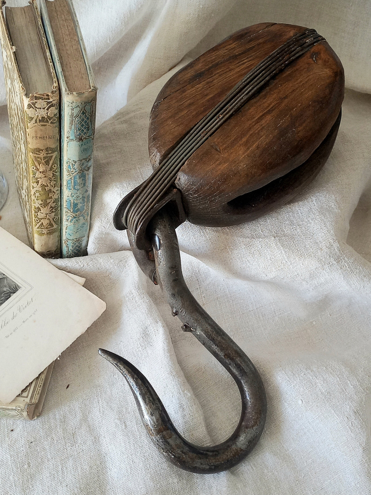 A beautiful aged antique wooden pulley block with a heavy metal hanging hook - a really fantastic piece with many decorative possibilities such a plant hanger or nautical/coastal decor.