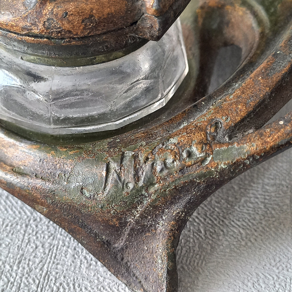 A stunning French art nouveau double inkwell with a goat figurine.

This wonderful antique inkwell has been sculpted in metal and signed by the artist (see photos). Behind the beautiful goat figurine are two pen rests and either side of the goat are two small glass ink pots with decorative metal lids.

The metal is finished in a lovely shade of green that has worn over time with traces of gold colour beneath - it has a wonderful patina of time all over it.