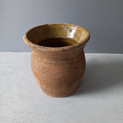 Small rustic vintage pottery jug with ochre glazed interior from France